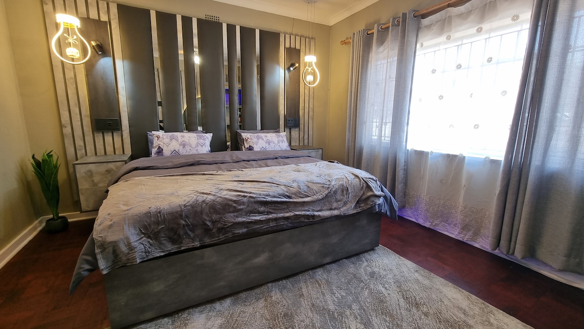 Super king size bed with USB plugs and LED spot reading lights.